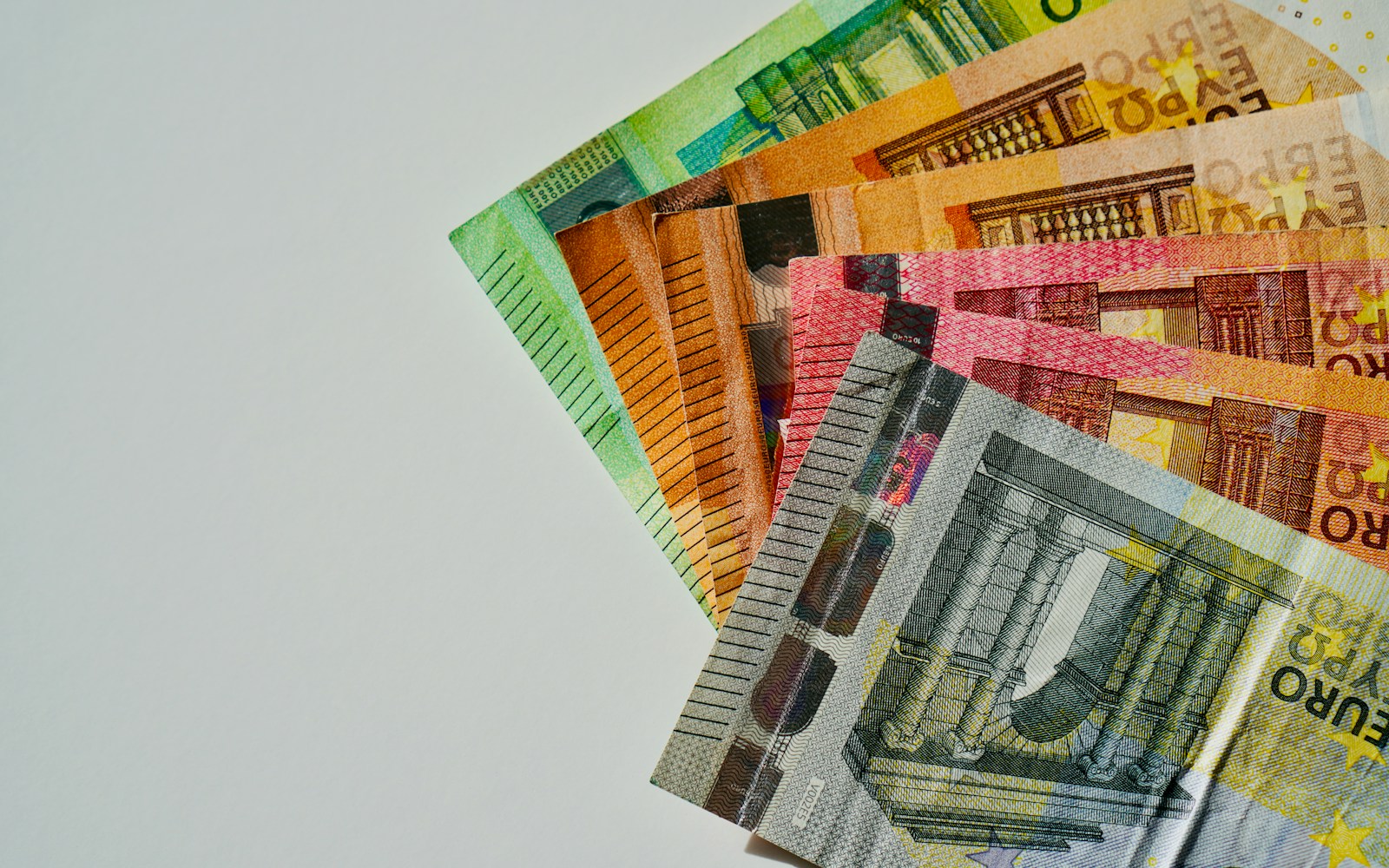 a pile of mexican currency sitting on top of each other