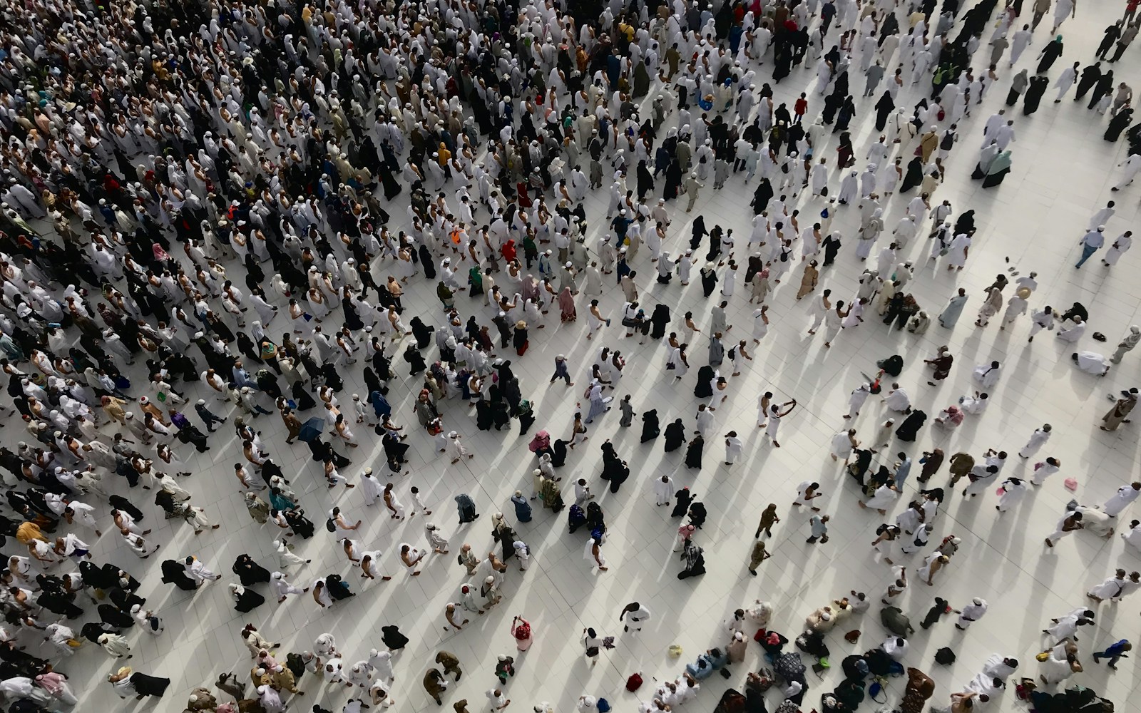 a large group of people standing in a large room