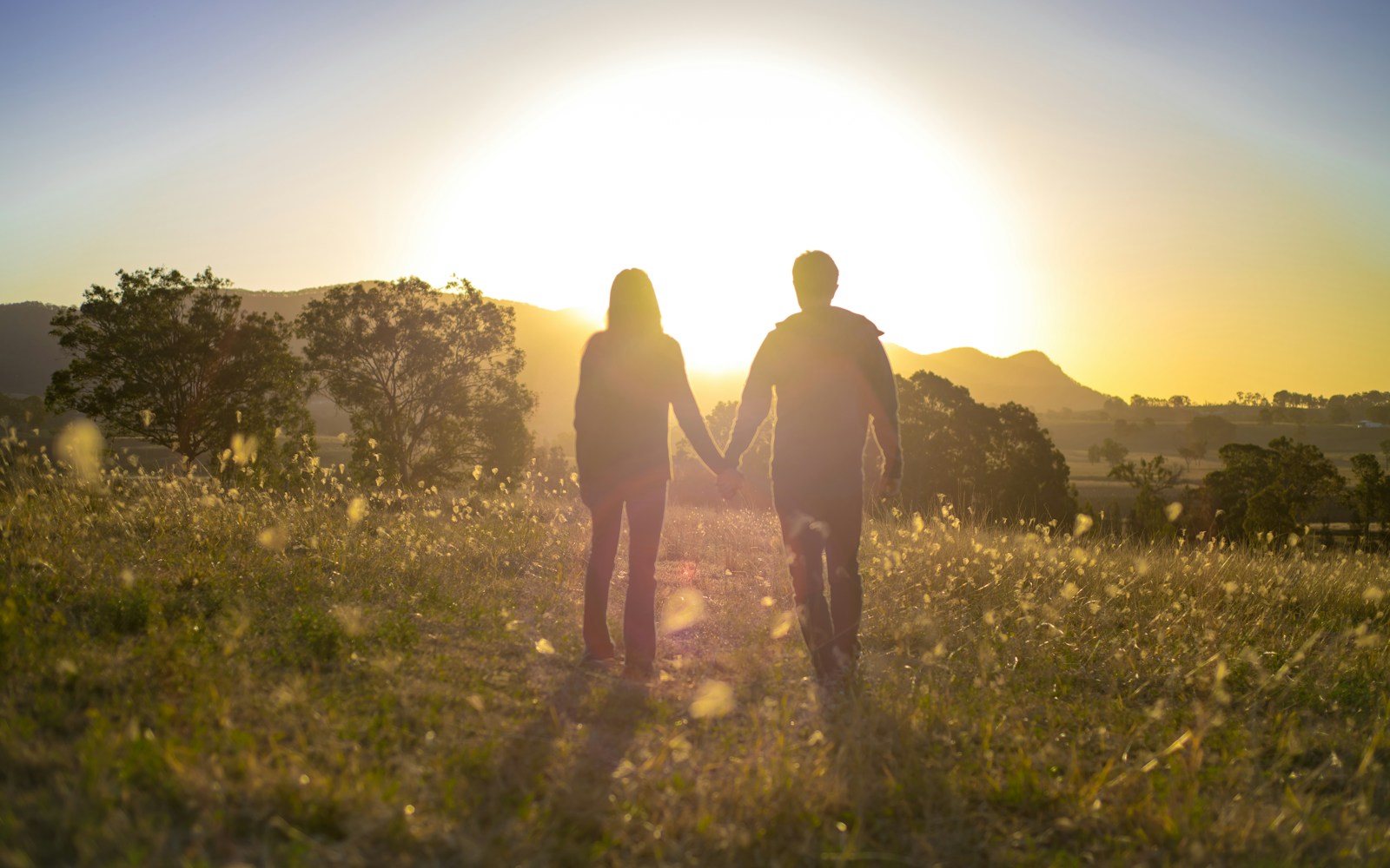 two people standing in a field