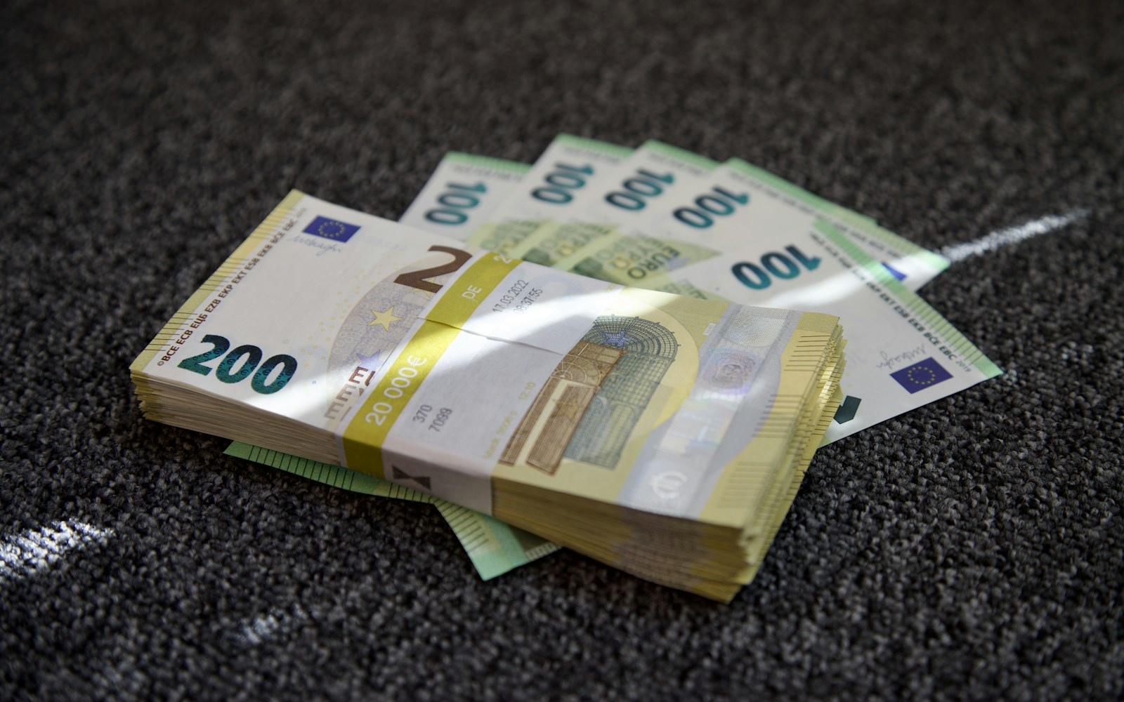 a pile of money sitting on top of a carpet
