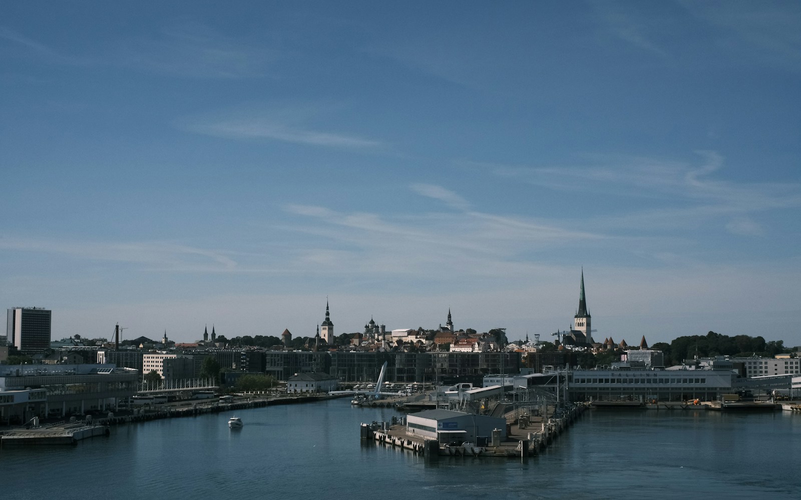 A harbor filled with lots of boats under a blue sky