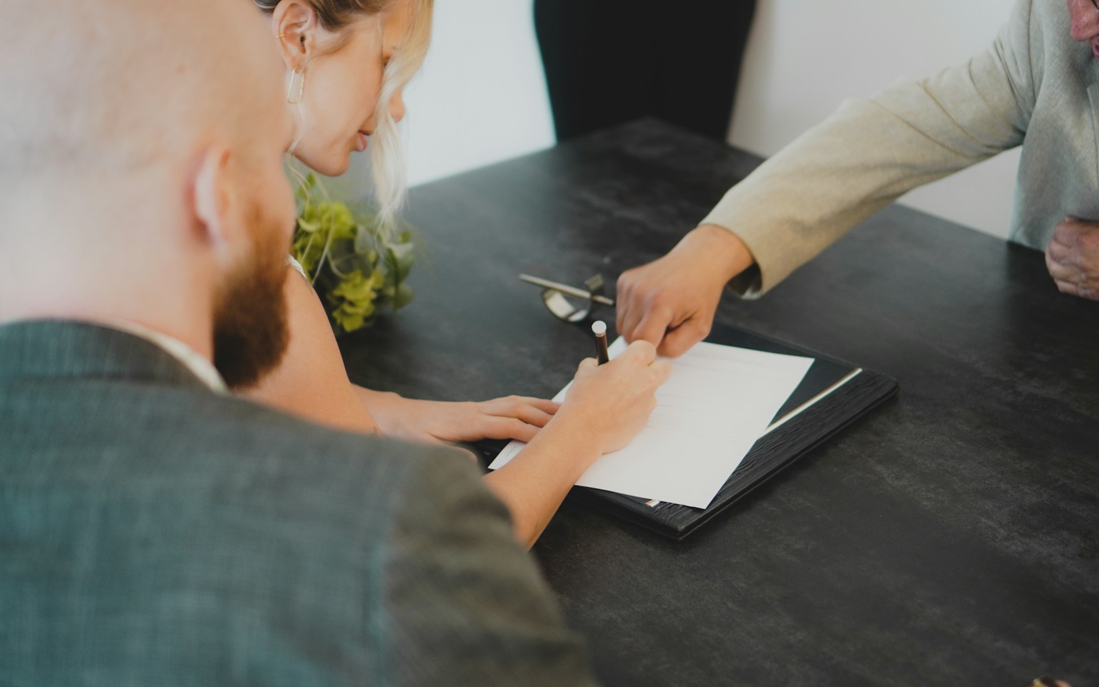 couple signing document at desk