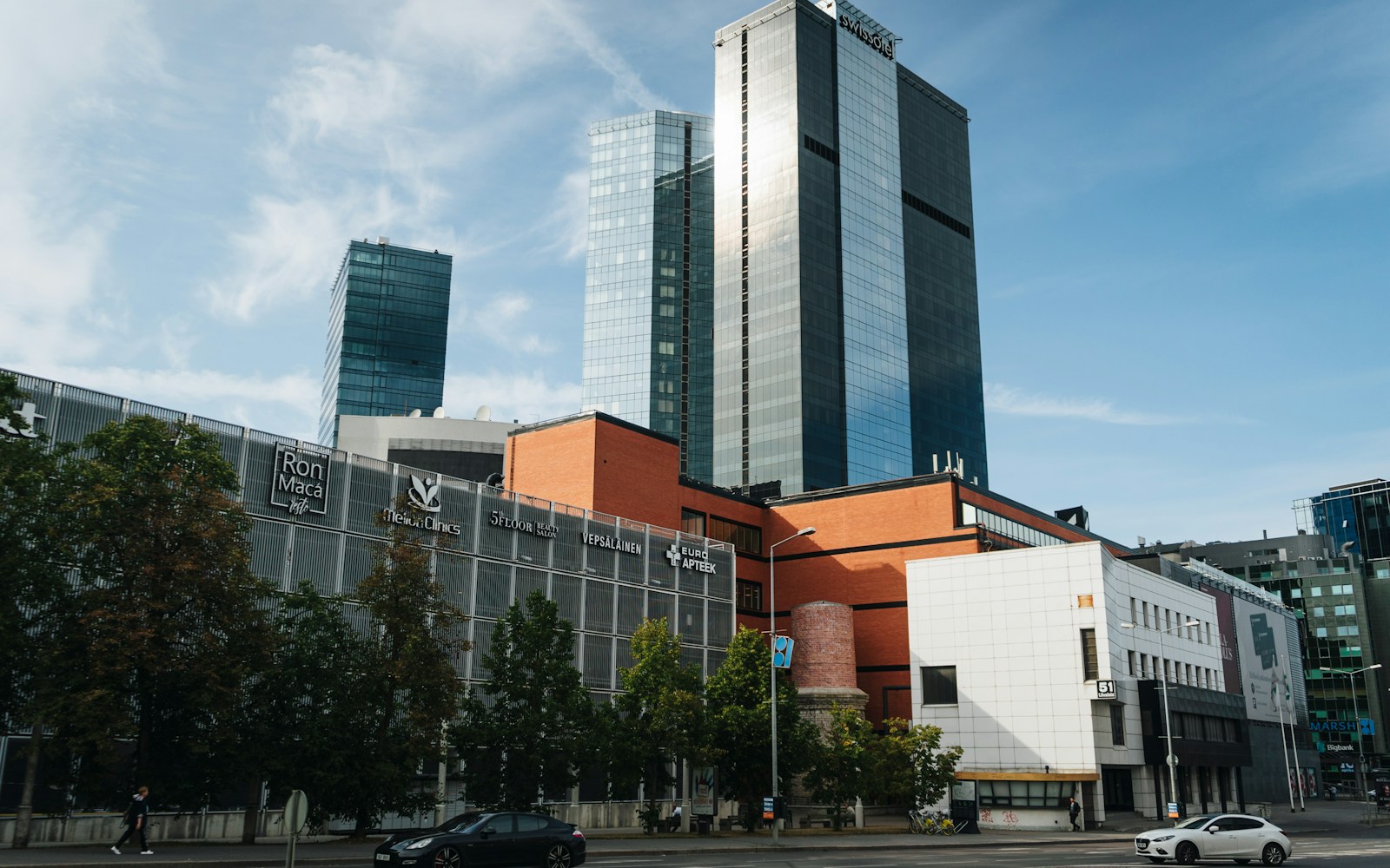 a city with tall buildings and cars on the street