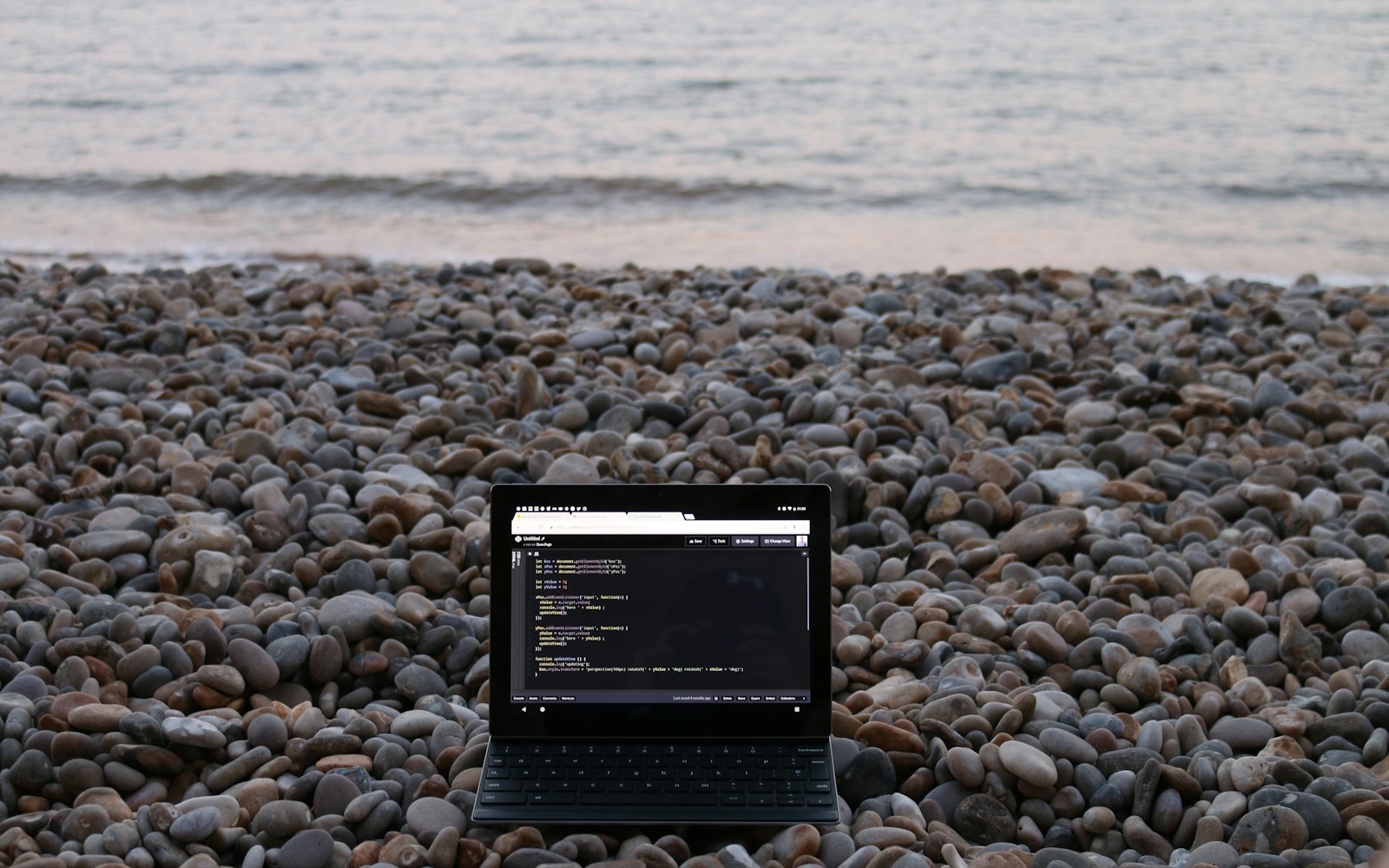 a tablet on a rocky beach
