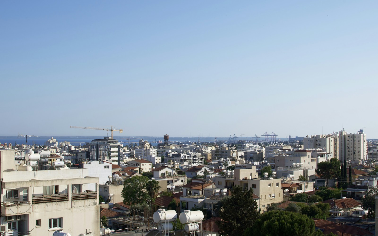 a city with a body of water in the background