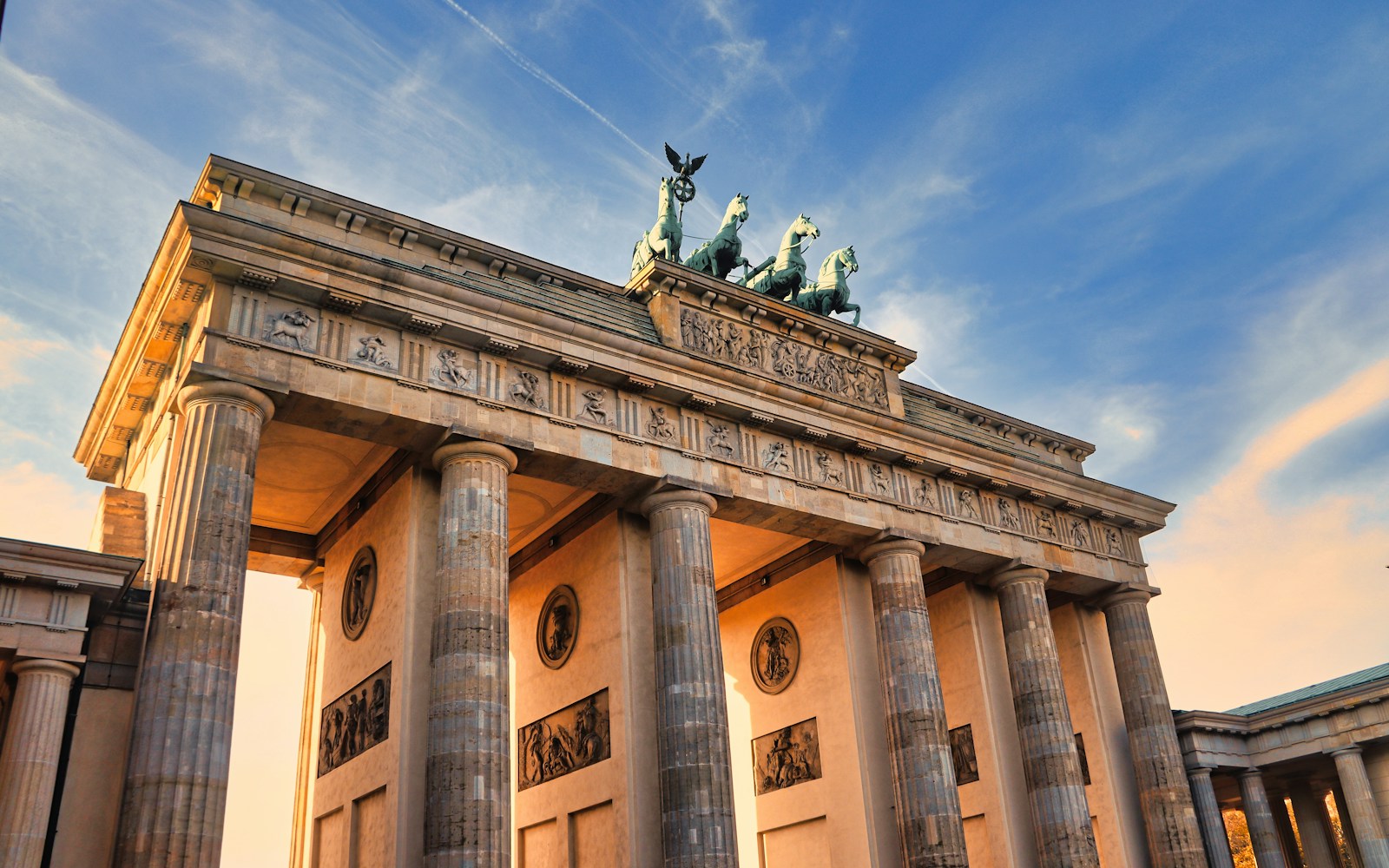 a very tall building with some statues on top of it