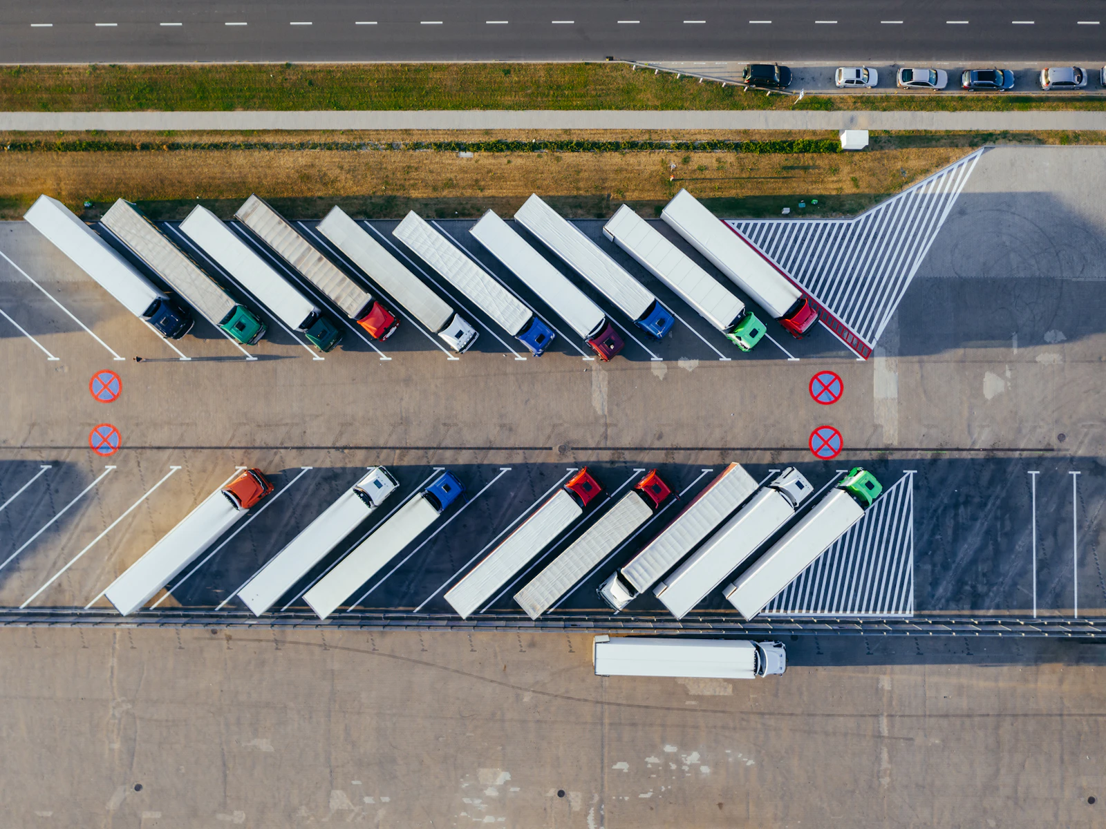 Fleet of parked freight trucks viewed from above